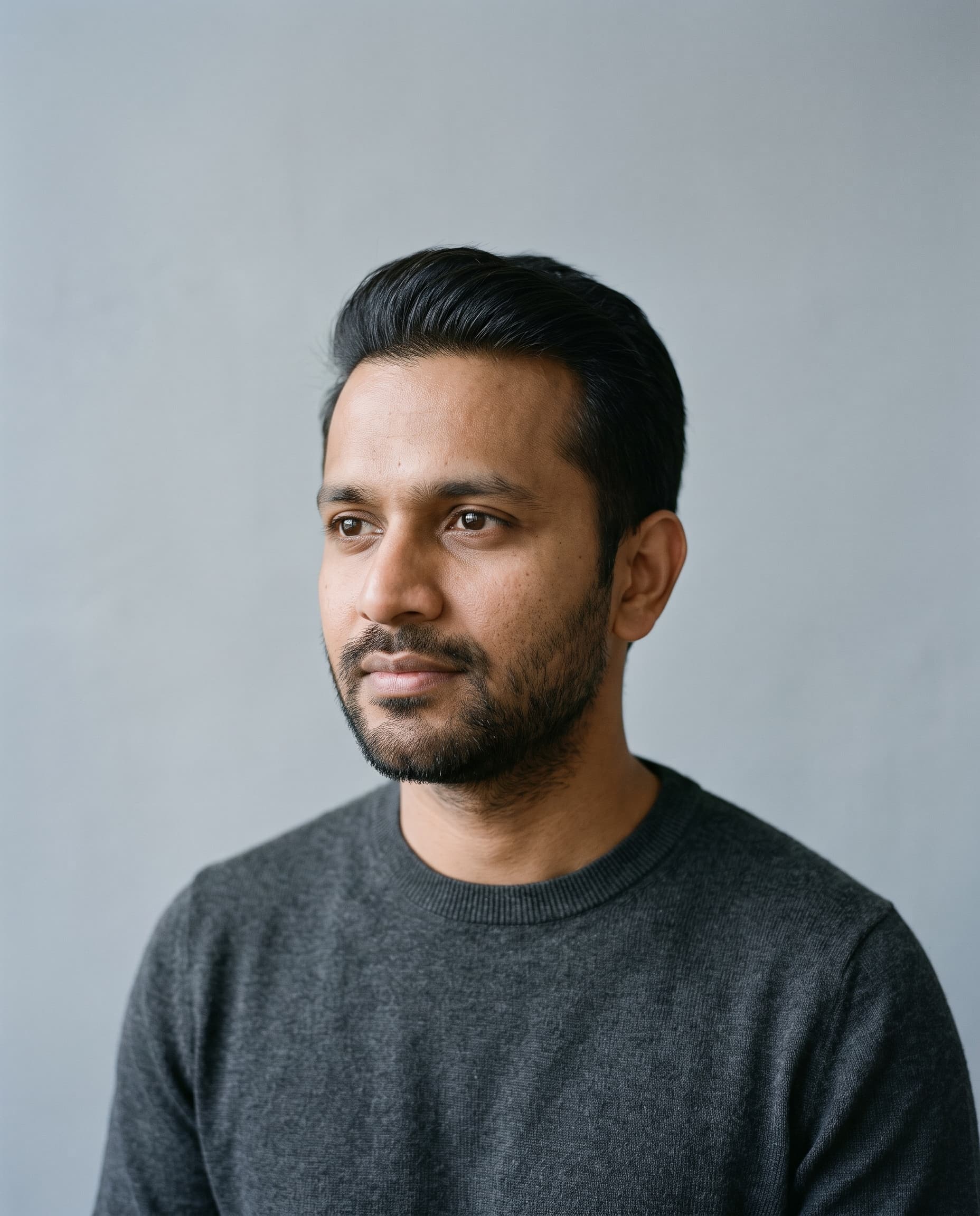 Portrait of a man in his thirties with a dense, natural hairline